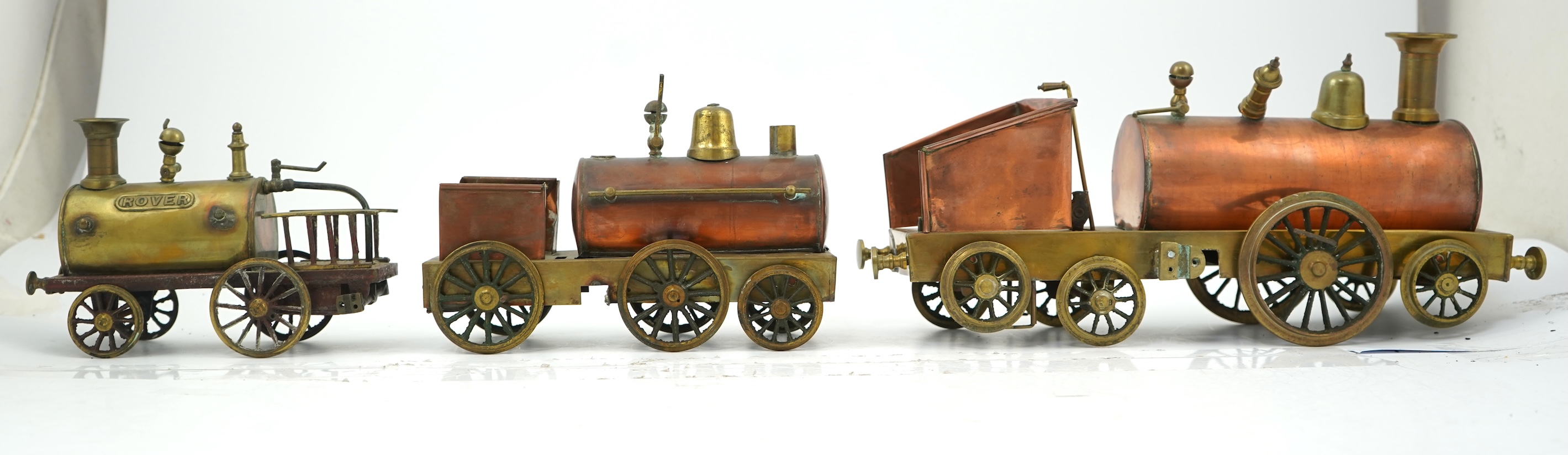 Three late 19th or early 20th century brass and copper live steam locomotives; a 2-2-4, ‘Monarch’, gauged to run on approximately 4 1/2 inch track, 33cm long frames, a 2-2-2, ‘Dragon’, gauged to run on approximately 3 1/
